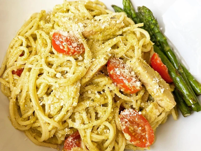Creamy pasta served with chopped tomatoes and asparagus.