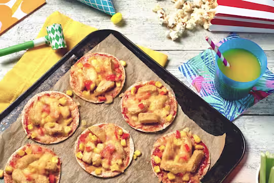 Small tortillas topped with tomato sauce, cheese, corn, and Quorn nuggets.