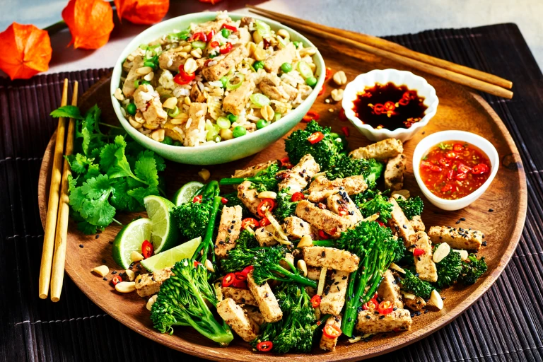 A Chinese-inspired sharing platter with fried rice with strips of Quorn Fillets and a broccoli and ginger stir fry with Quorn Chinese Inspired Salt & Pepper Strips and two sauces.