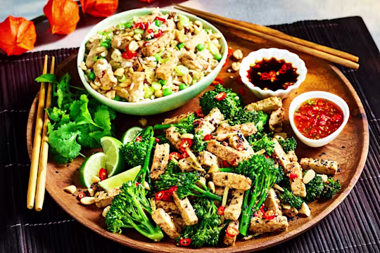 A Chinese-inspired sharing platter with fried rice with strips of Quorn Fillets and a broccoli and ginger stir fry with Quorn Chinese Inspired Salt & Pepper Strips and two sauces.