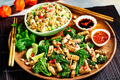 serving plate with bowl of egg fried rice with Quorn pieces next to quorn piece stir fry and dipping sauces