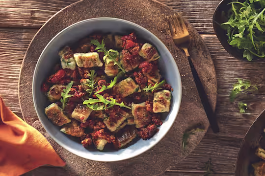 Vegetarian Gnocchi with a Quorn Mince Ragu, made with Quorn Mince, tomato, red wine, onion, garlic and cinnamon, served in a bowl.