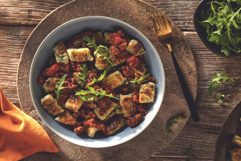 Vegetarian Gnocchi with a Quorn Mince Ragu, made with Quorn Mince, tomato, red wine, onion, garlic and cinnamon, served in a bowl.