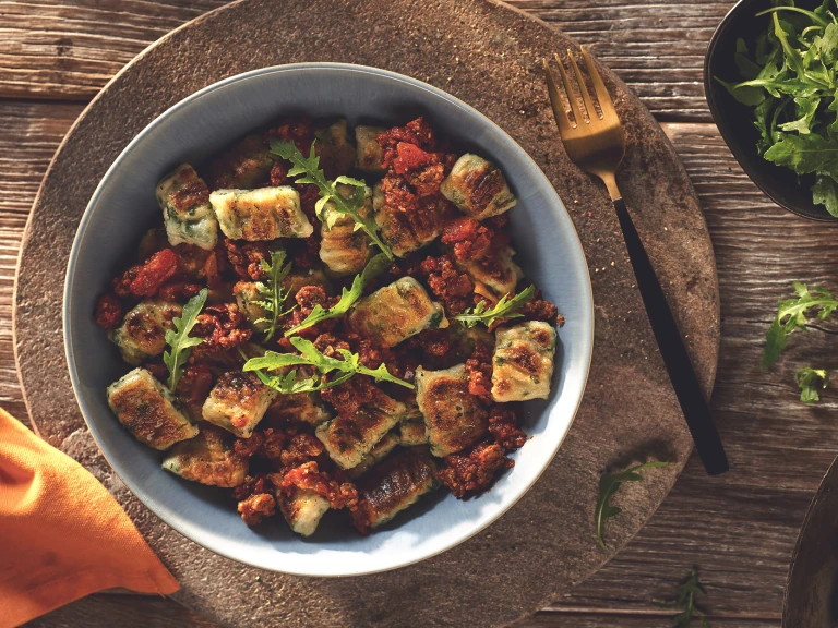 Vegetarian Gnocchi with a Quorn Mince Ragu, made with Quorn Mince, tomato, red wine, onion, garlic and cinnamon, served in a bowl.