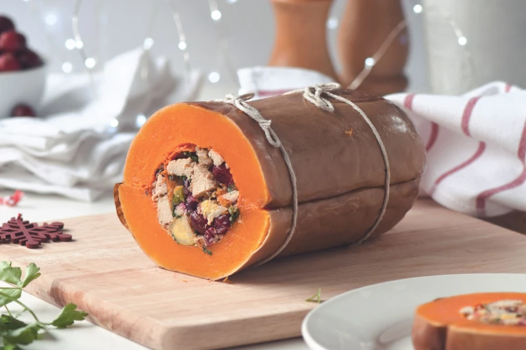A butternut squash that has been stuffed with red onion, Brussels sprouts, cranberries, quinoa, and  Quorn Vegan Pieces.