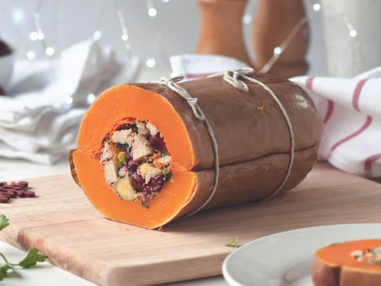 A butternut squash that has been stuffed with red onion, Brussels sprouts, cranberries, quinoa, and  Quorn Vegan Pieces.