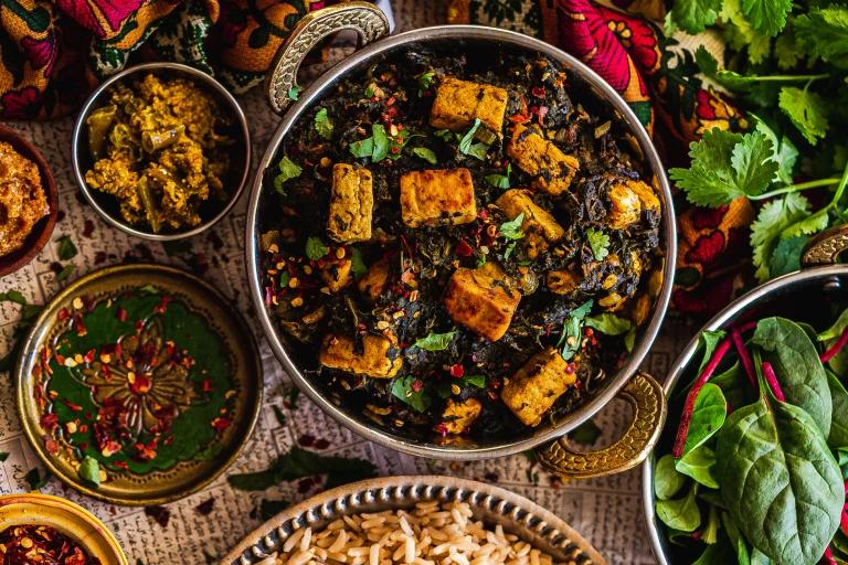 A vegan palak paneer made with spinach and Quorn Vegan Pieces topped with chilli and coriander in a balti dish.