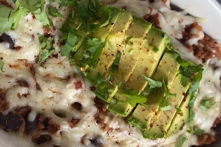 Brown rice chilli cheese bake topped with chopped avocado and fresh coriander.