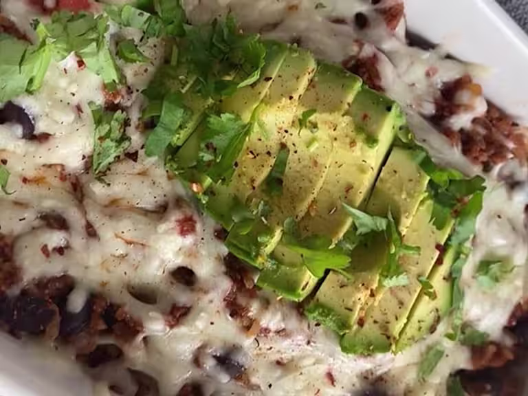 Brown rice chilli cheese bake topped with chopped avocado and fresh coriander.