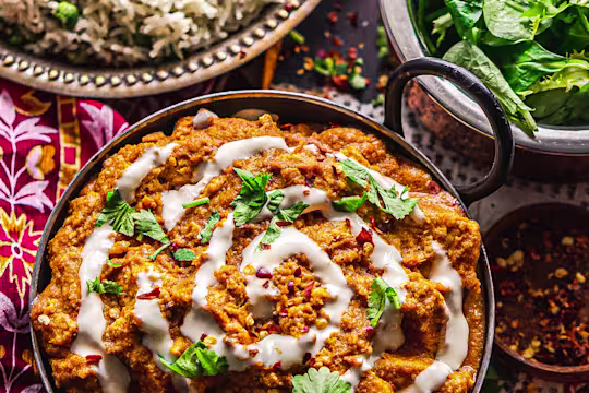 A vegan butter chicken curry made with Quorn Vegan Pieces topped with a swirl of vegan yogurt.