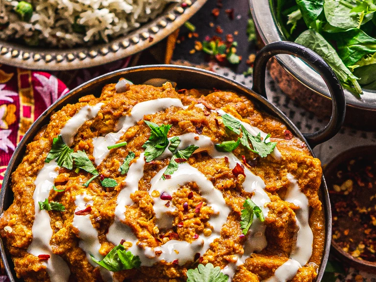 A vegan butter chicken curry made with Quorn Vegan Pieces topped with a swirl of vegan yogurt.