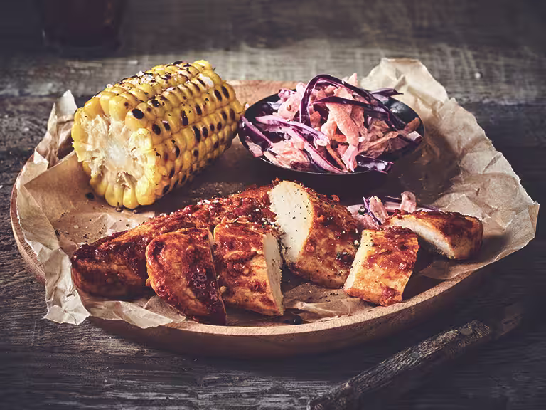 Healthy dinner idea made with Quorn Piri Piri Fillets and homemade slaw and a corn cob, served on baking paper