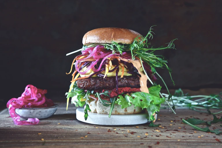 Burger recipe made with a Quorn Quarter Pounder layered with lettuce, beetroot, salad, pickled red onion and beansprouts