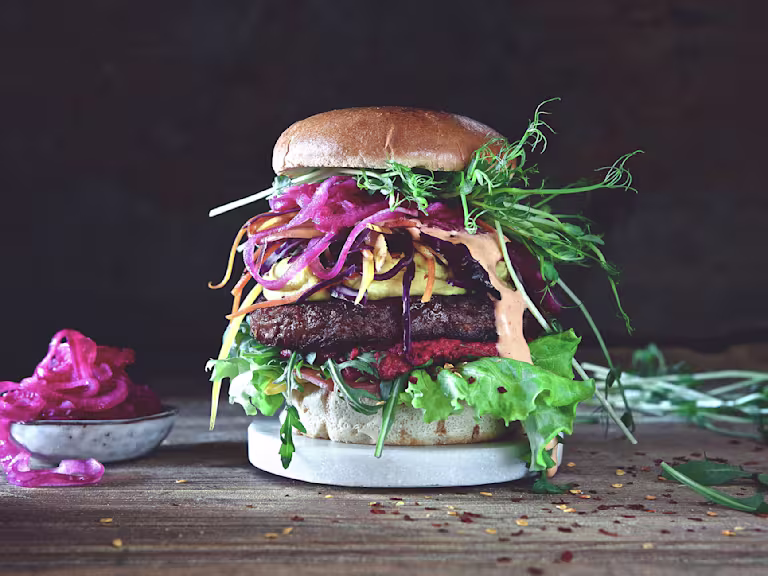 Burger recipe made with a Quorn Quarter Pounder layered with lettuce, beetroot, salad, pickled red onion and beansprouts