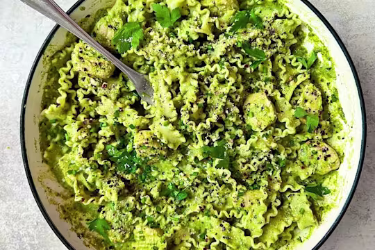 A large bowl of vegetarian spring greens pasta made with Quorn Pieces.