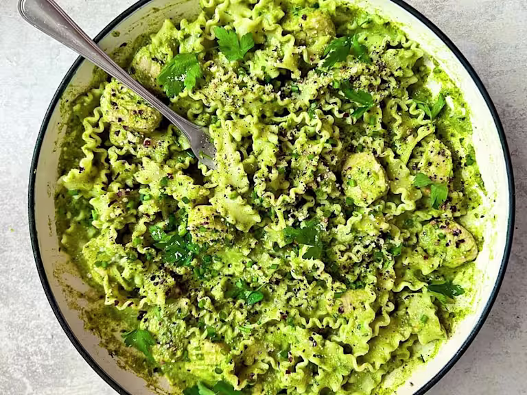 A large bowl of vegetarian spring greens pasta made with Quorn Pieces.