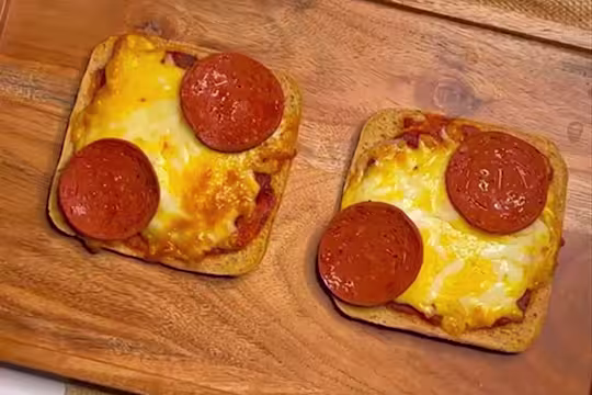 Two slices of toast topped with pizza sauce, melted cheese and Quorn Vegan Pepperoni