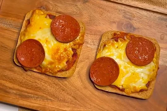 Two slices of toast topped with pizza sauce, melted cheese and Quorn Vegan Pepperoni