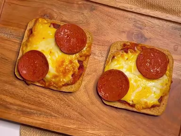 Two slices of toast topped with pizza sauce, melted cheese and Quorn Vegan Pepperoni