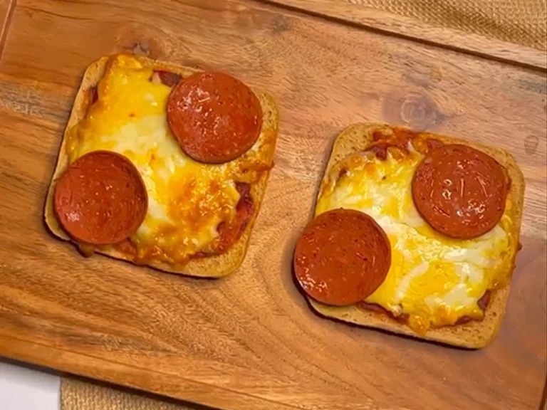 Two slices of toast topped with pizza sauce, melted cheese and Quorn Vegan Pepperoni 