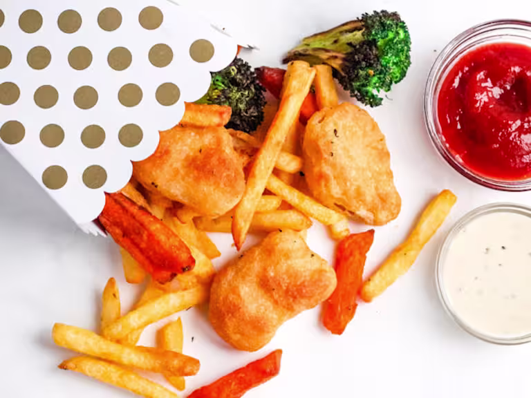 Quorn Crispy Nuggets and fries spilling out of a serving box.