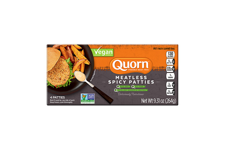 A box of Quorn Vegan Meatless Spicy Patties showing the plated product and information on a charcoal and orange background.