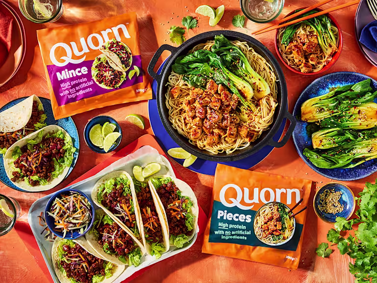 High protein Quorn Mince and Pieces on a table with recipes featuring the products