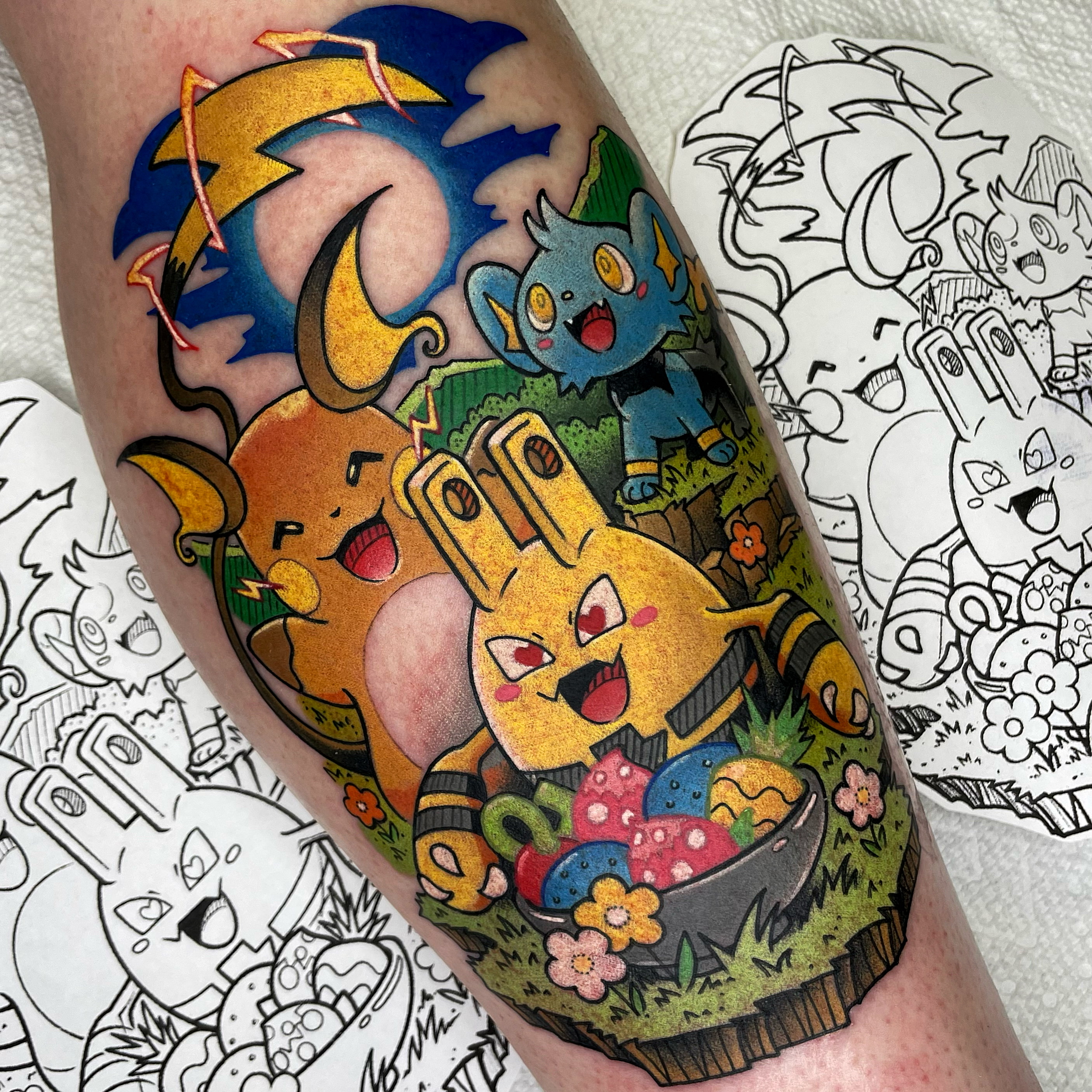 A colorful tattoo of three anime characters