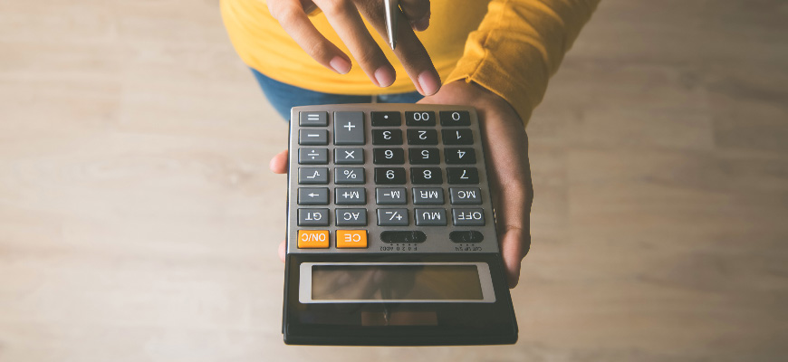 Person holding a calculator