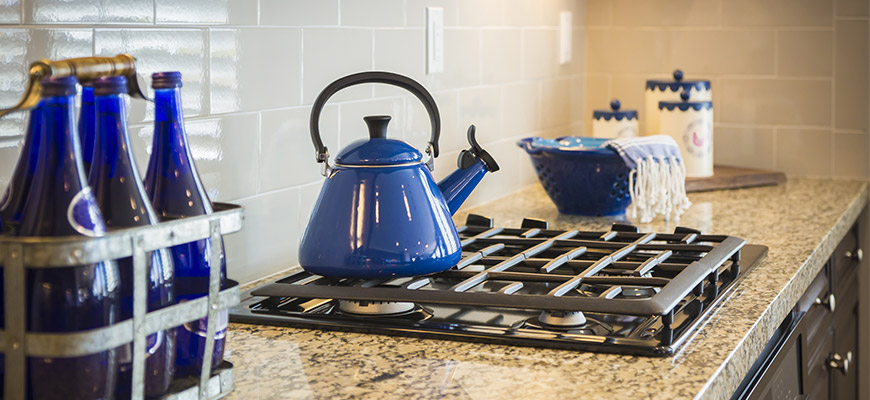 A row of nice low-rise condo buildings with blue sky behind them. 