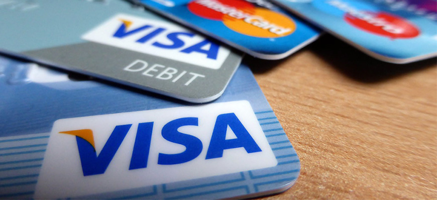 This image of credit cards: Visas and Mastercards spread out. 