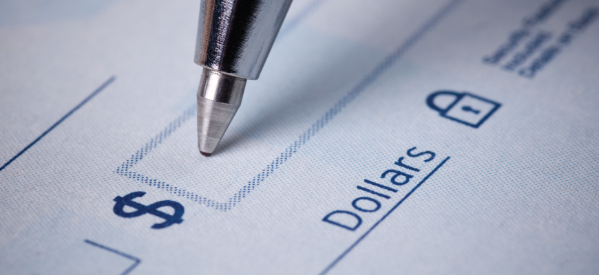 Example of a completed Canadian cheque showing where to write the date, payee name, amount in numbers and words, memo, and signature.