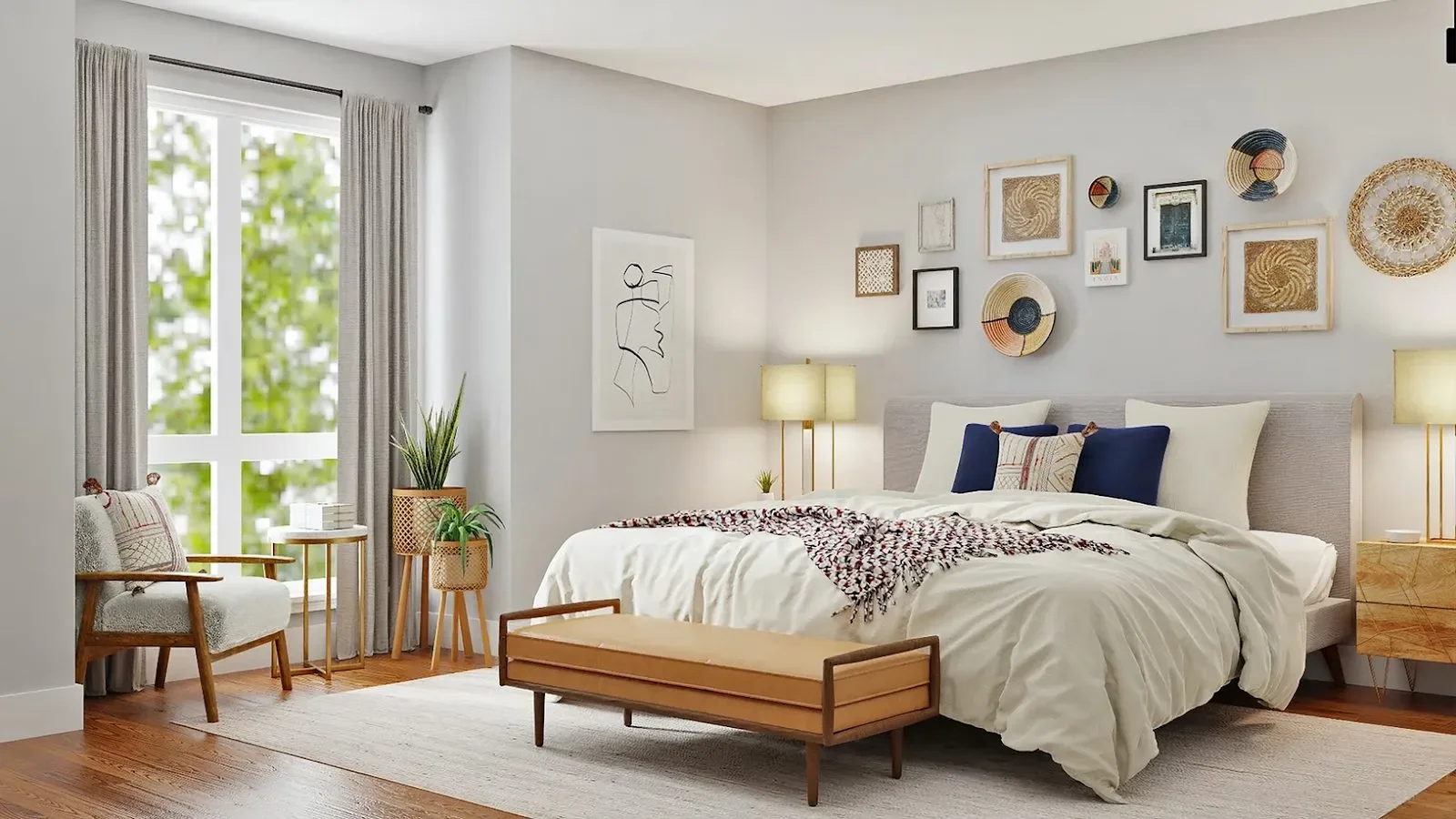 Bright, minimalist bedroom featuring a gray upholstered bed with cream bedding and navy pillows, wooden mid-century furniture, large windows with gray curtains, potted plants, gallery wall with framed artwork and woven baskets, and warm wood flooring.