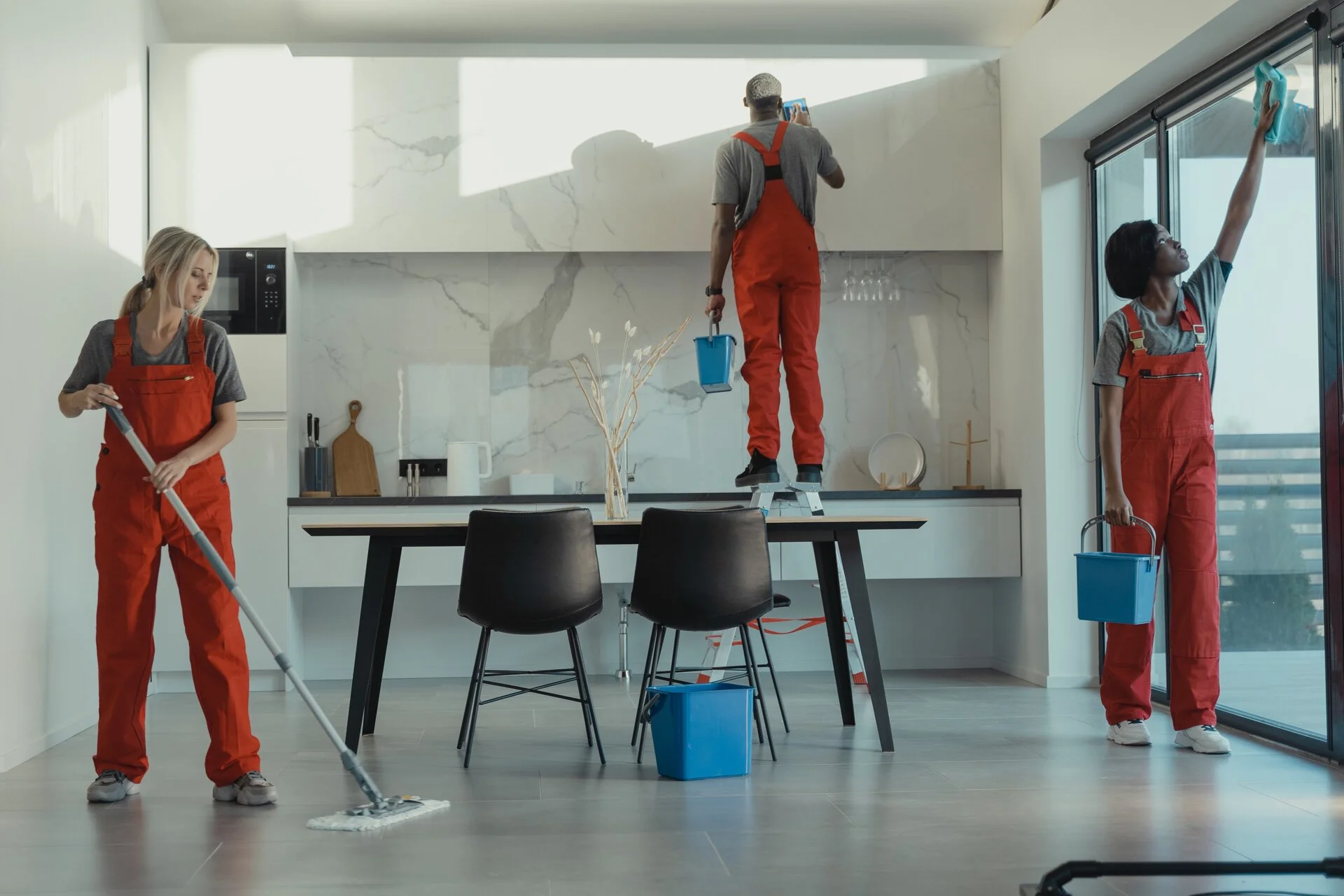 kitchen cleaning crew in orange overalls