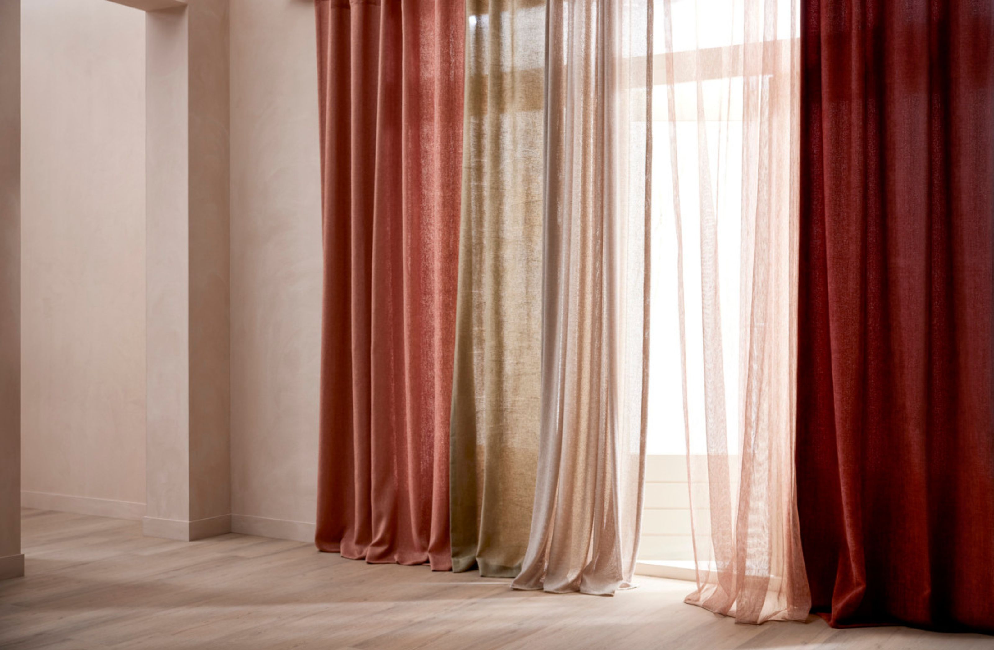 Elegante gordijnen in warme tinten van roze, beige en bordeauxrood voor een raam met zacht licht dat binnenvalt.