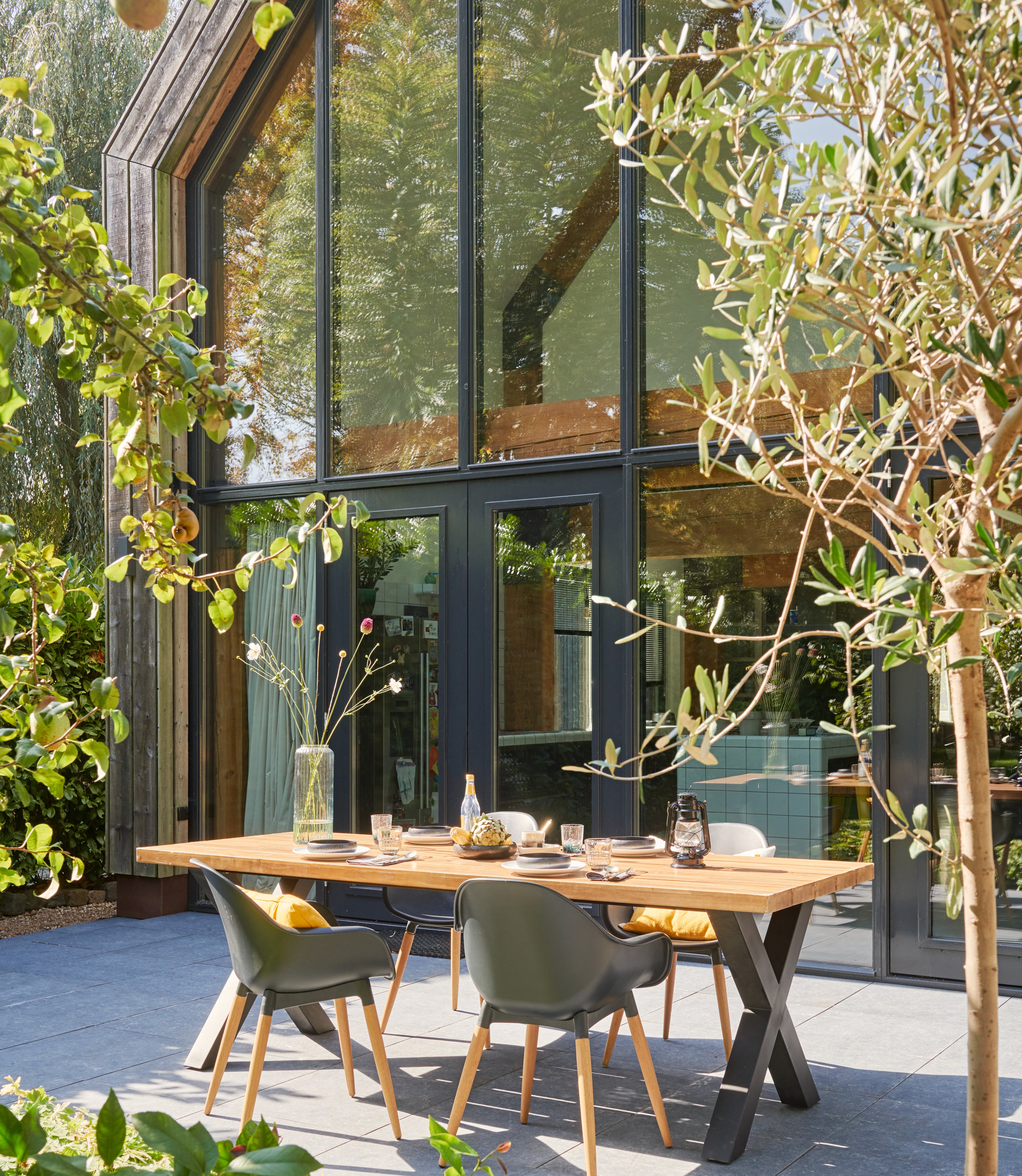 Gedekte tuintafel voor een keukenraam