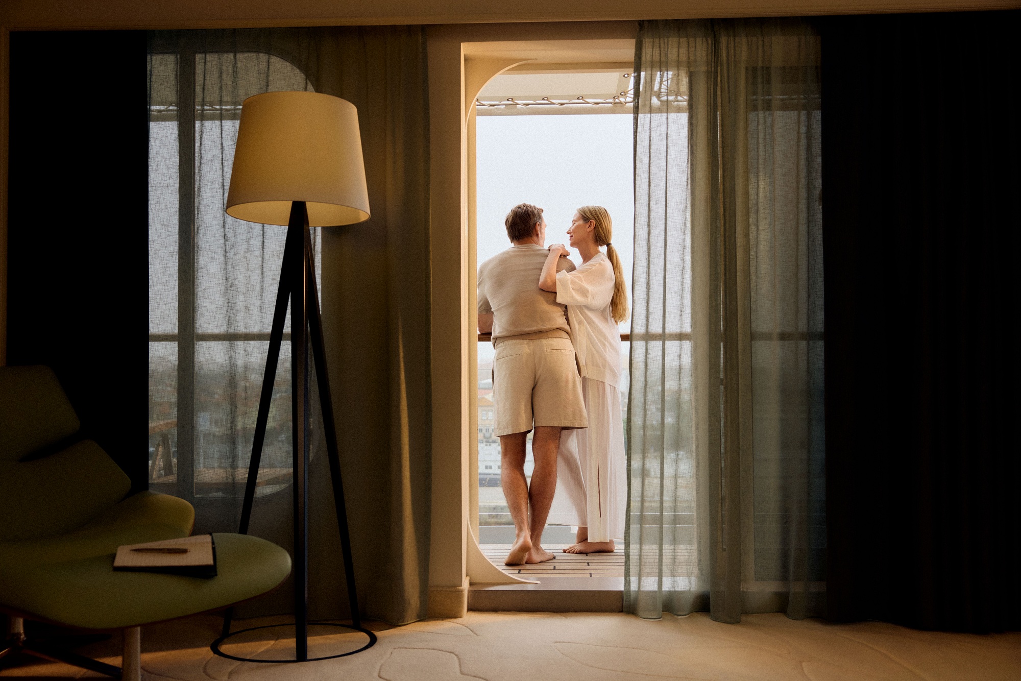 View from a suite of a couple on the balcony of a Hapag-Lloyd Cruises ship