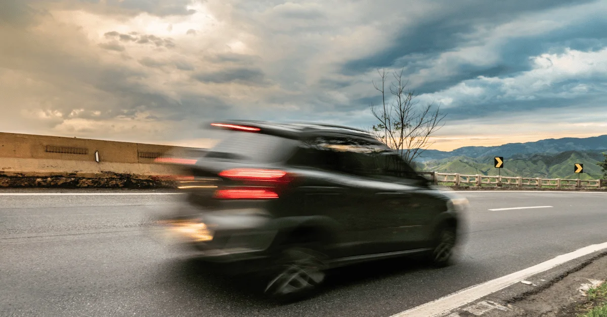 Car speeding past a speed camera Car speeding past a speed camera