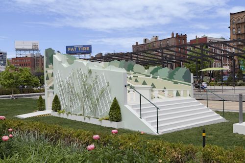 Meredith James
Far from this setting in which I now find myself, 2017
Wood, metal, and acrylic paint
Approx. 35 x 16 x 15 feet
Installation at the Rose Kennedy Greenway, Boston, MA

This sculpture is an optical illusion called an Ames Room. An Ames Room is a three-walled trapezoidal room built with a false perspective so it appears square and regular from one viewpoint while people inside the room seem to be different sizes depending on where they stand.

