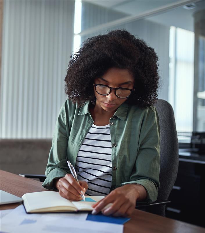 woman writing in notebook