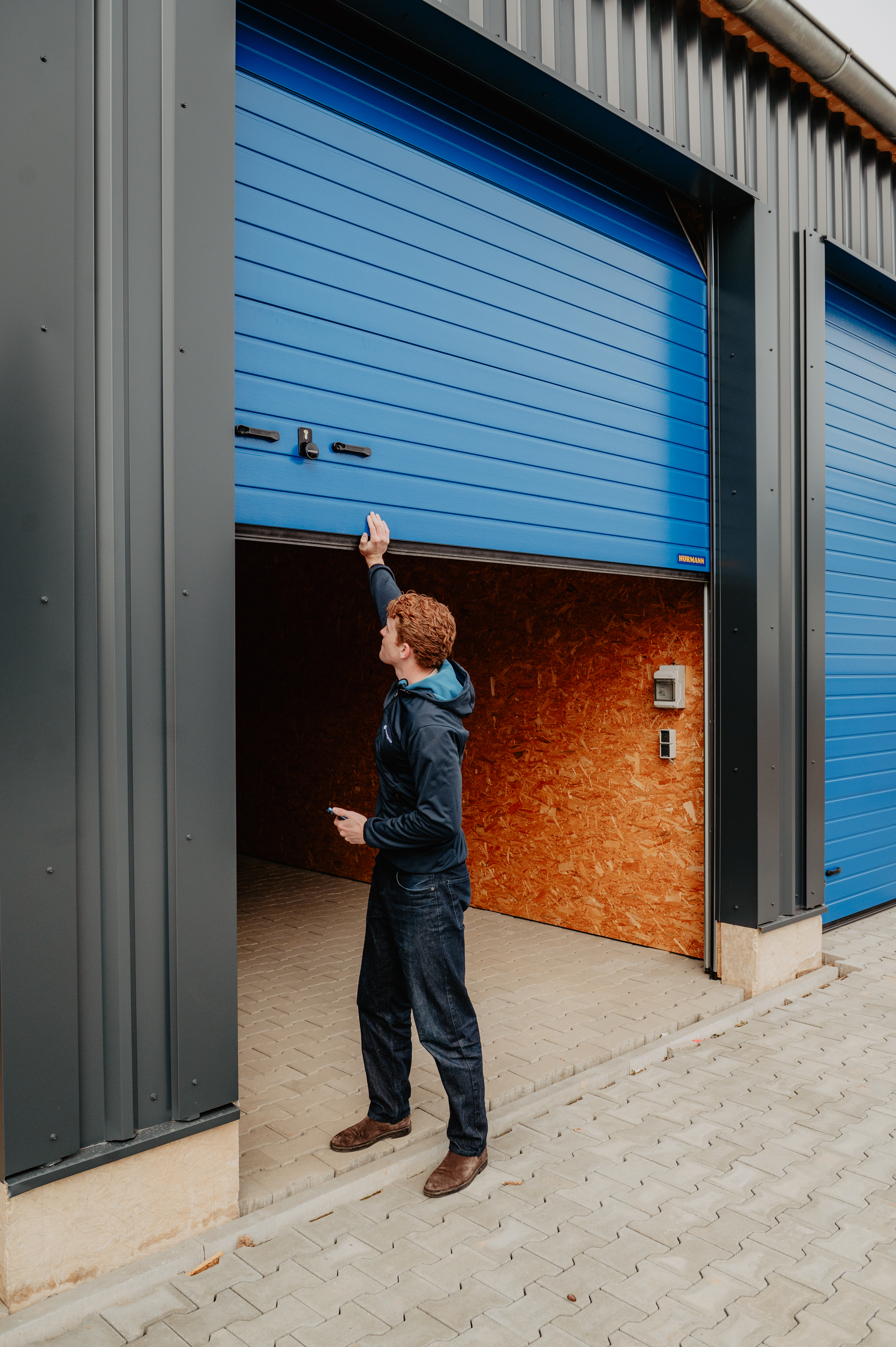 A man opens a garage door