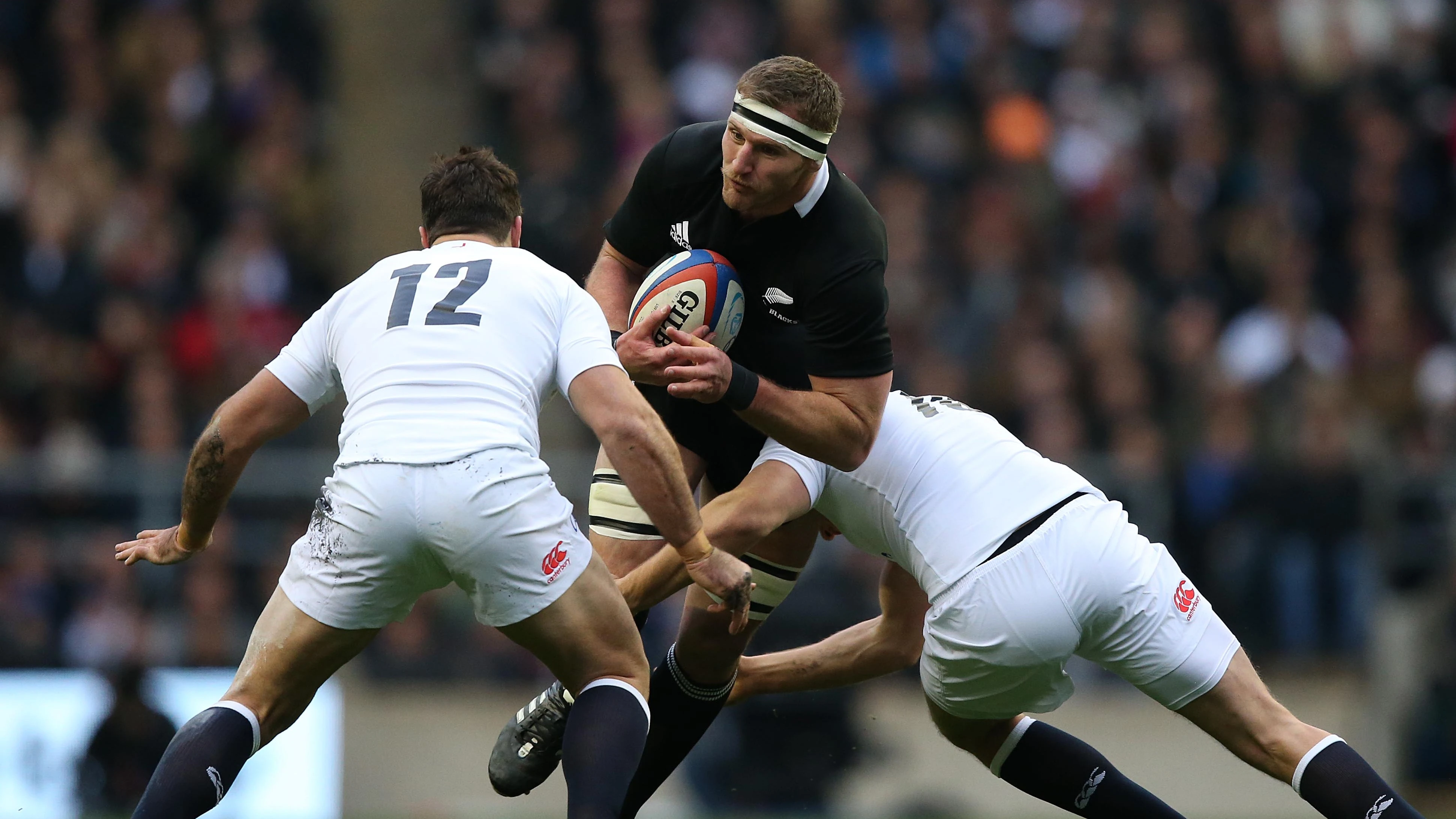 New Zealand's Kieran Read is tackled by two English players during the 2012 autumn match at Twickenham.