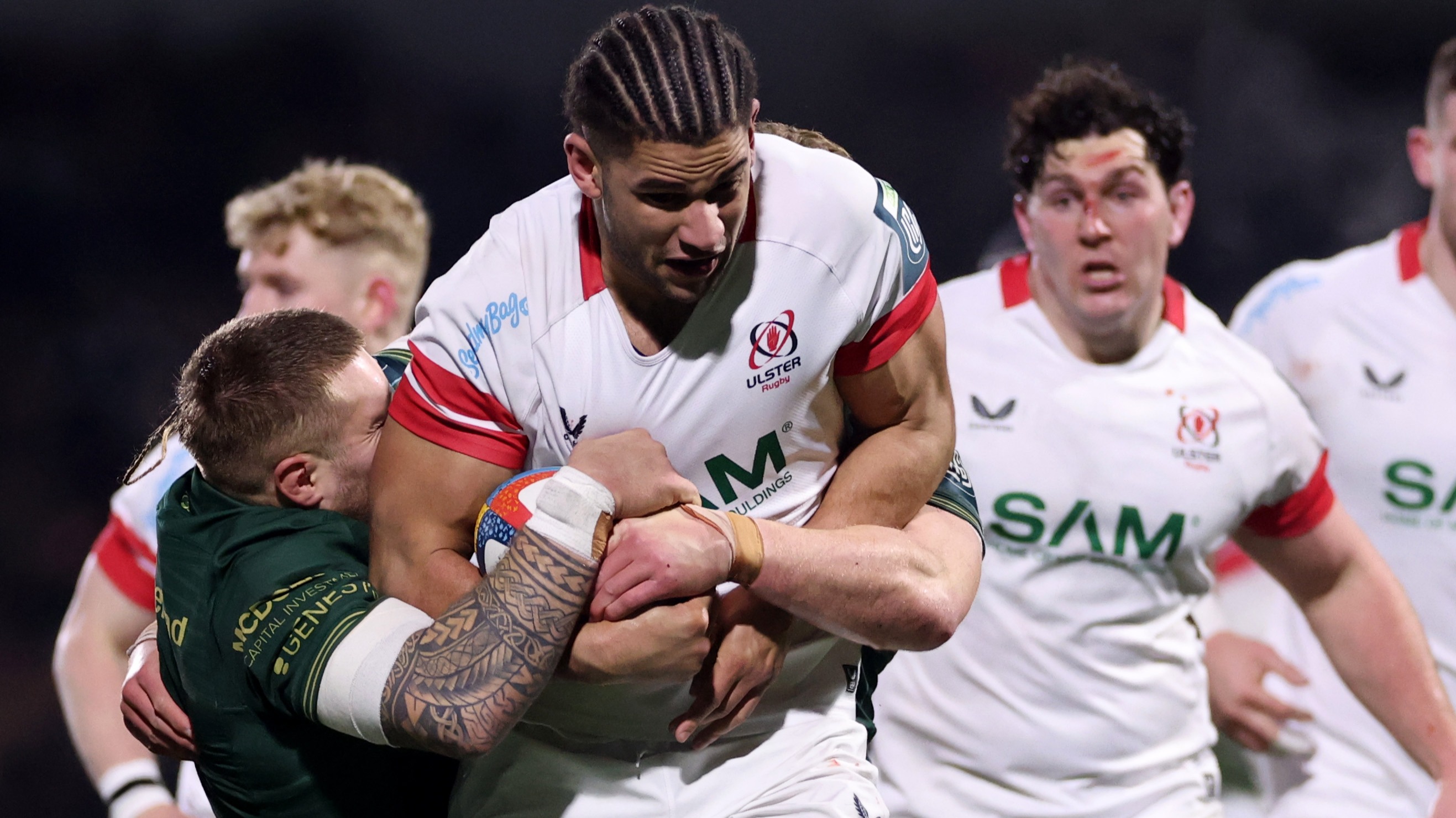 Ulster's Cormac Izuchukwu is tackled by Munster's Sean Jansen and Cian Prendergast 