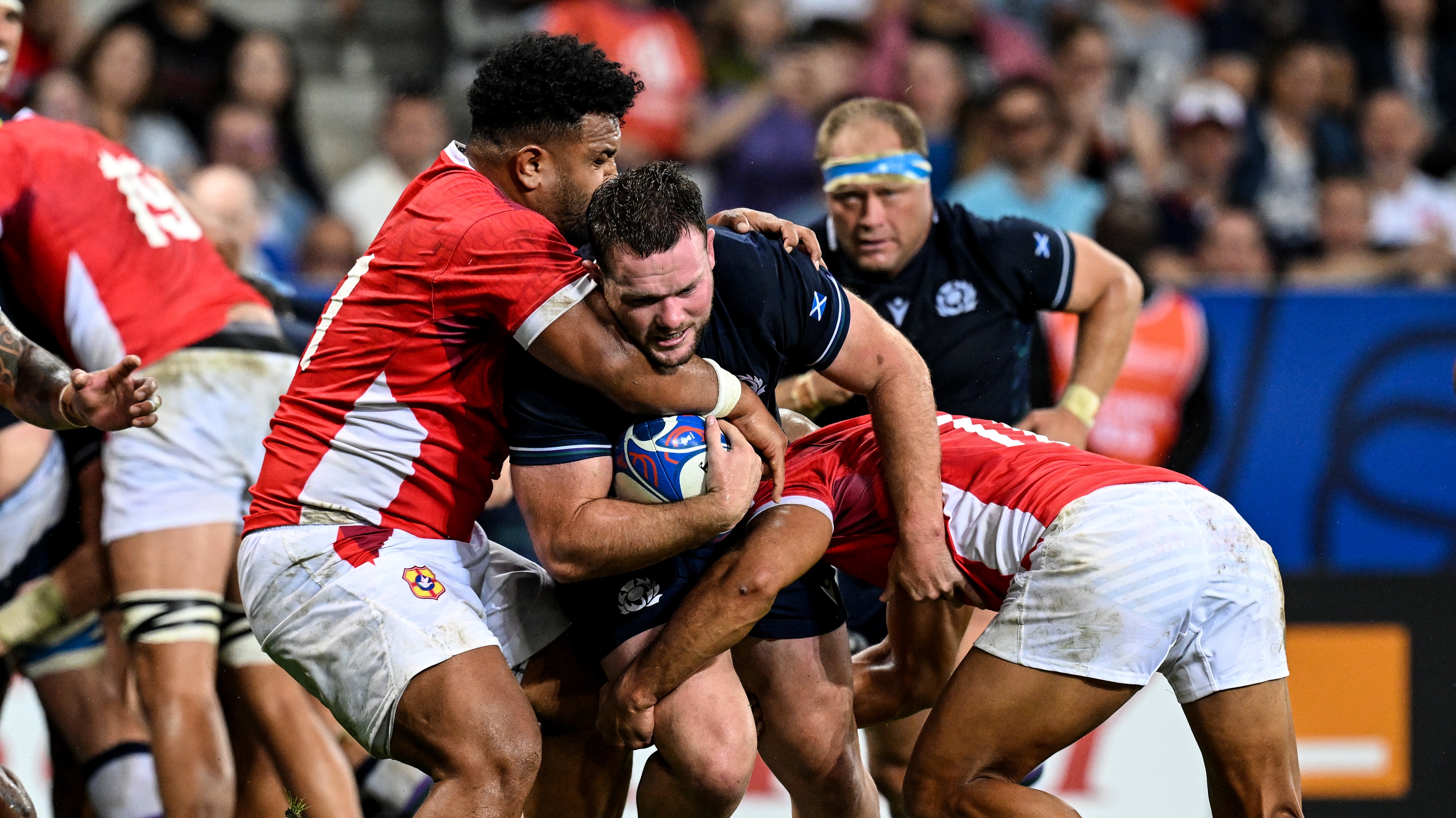 Tonga's Sione Vailanu tackles Scotland's Ewan Ashman.