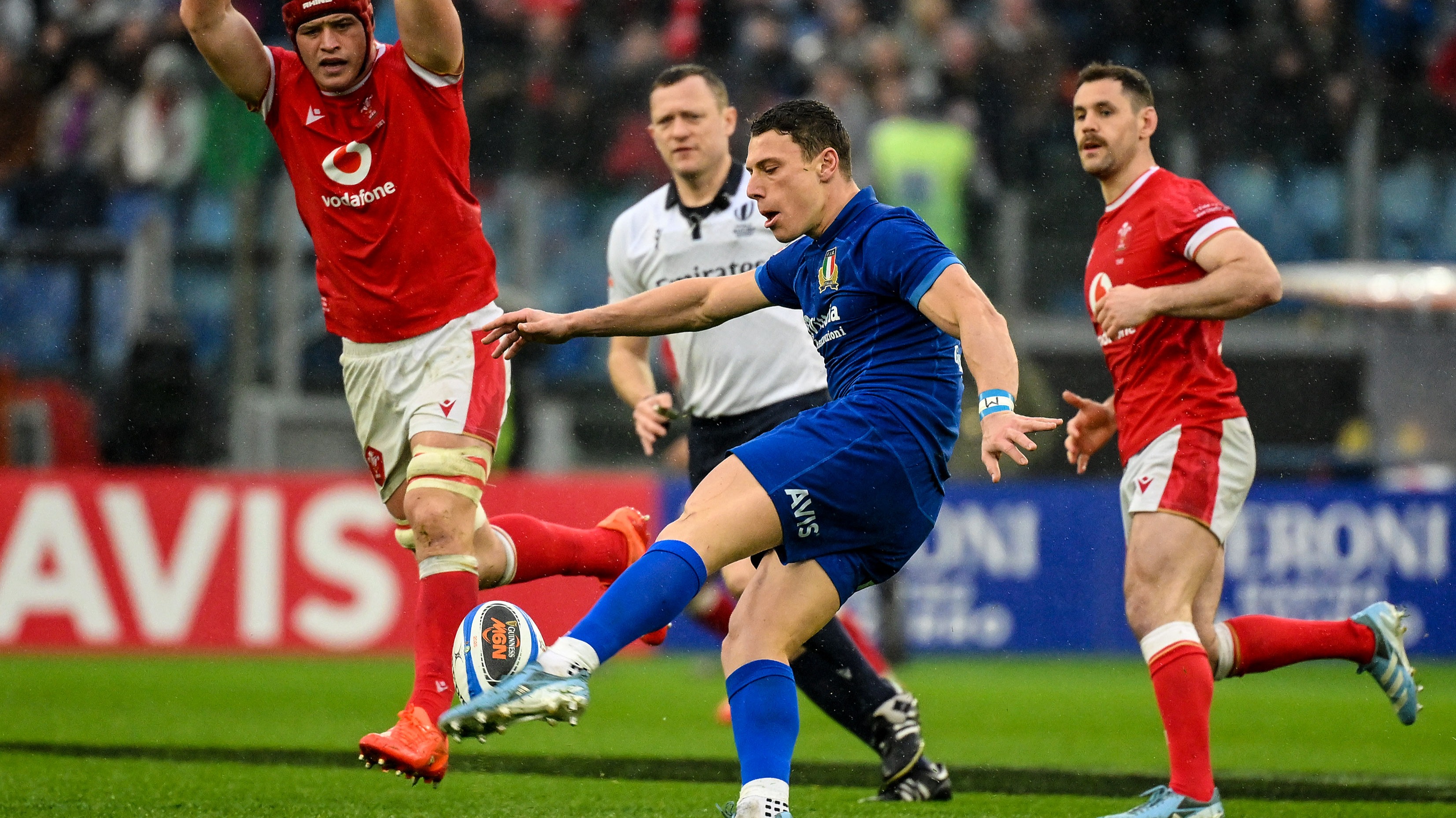 Wales players attempt to charge down Italy's Paolo Garbisi's kick during the 2025 Guinness Six Nations Championship in Stadio Olimpico, Rome.