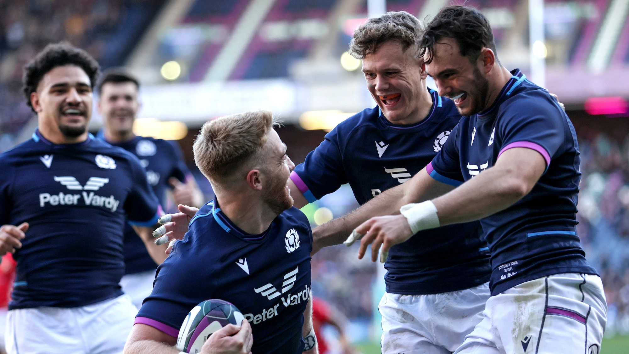 Kyle Steyn celebrates scoring his second try with Darcy Graham and Rufus McLean 30/10/2021