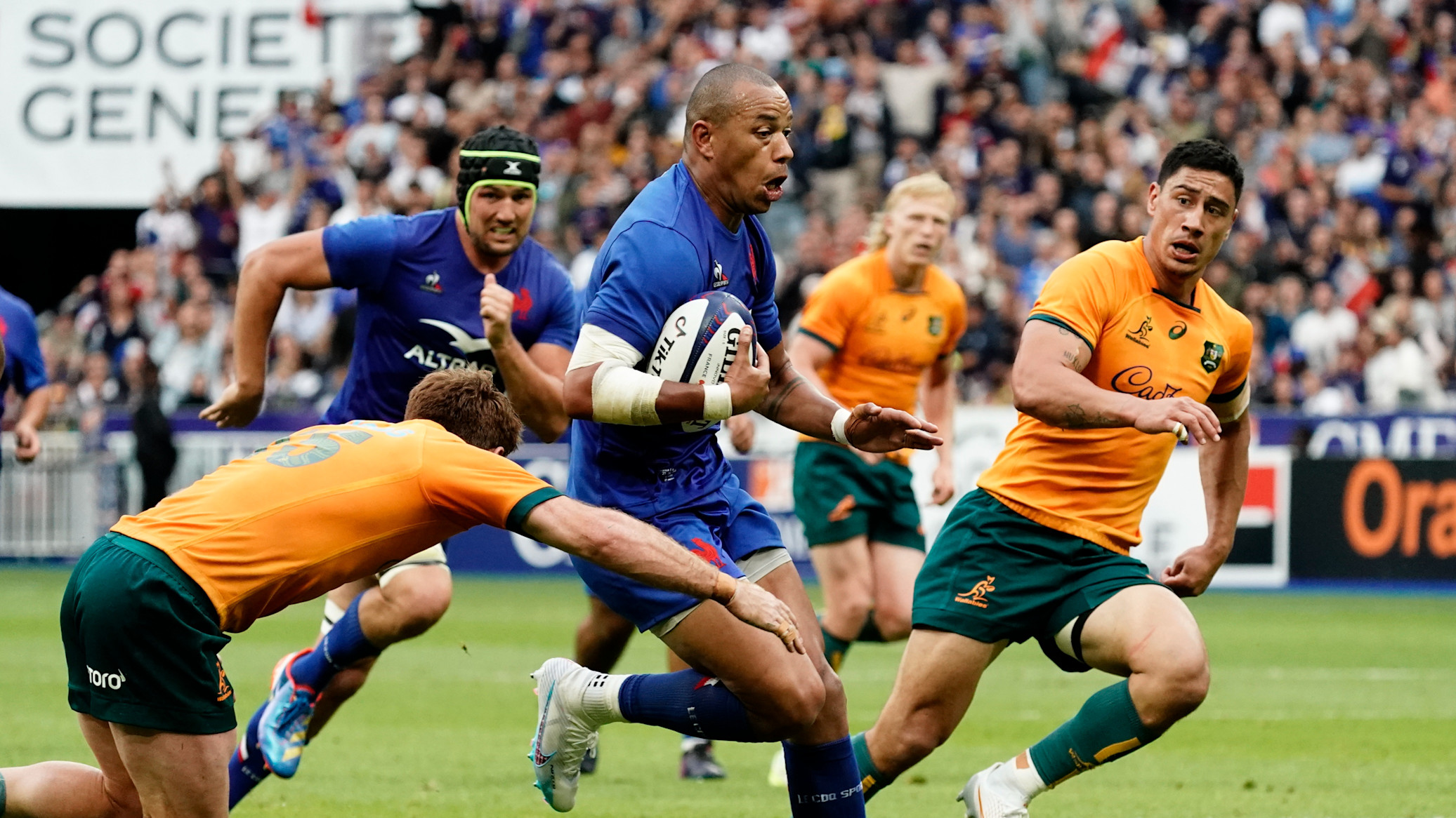 France's Gaël Fickou attempts to escape the clutches of the Australian defence in a 2023 World Cup warm-up match.