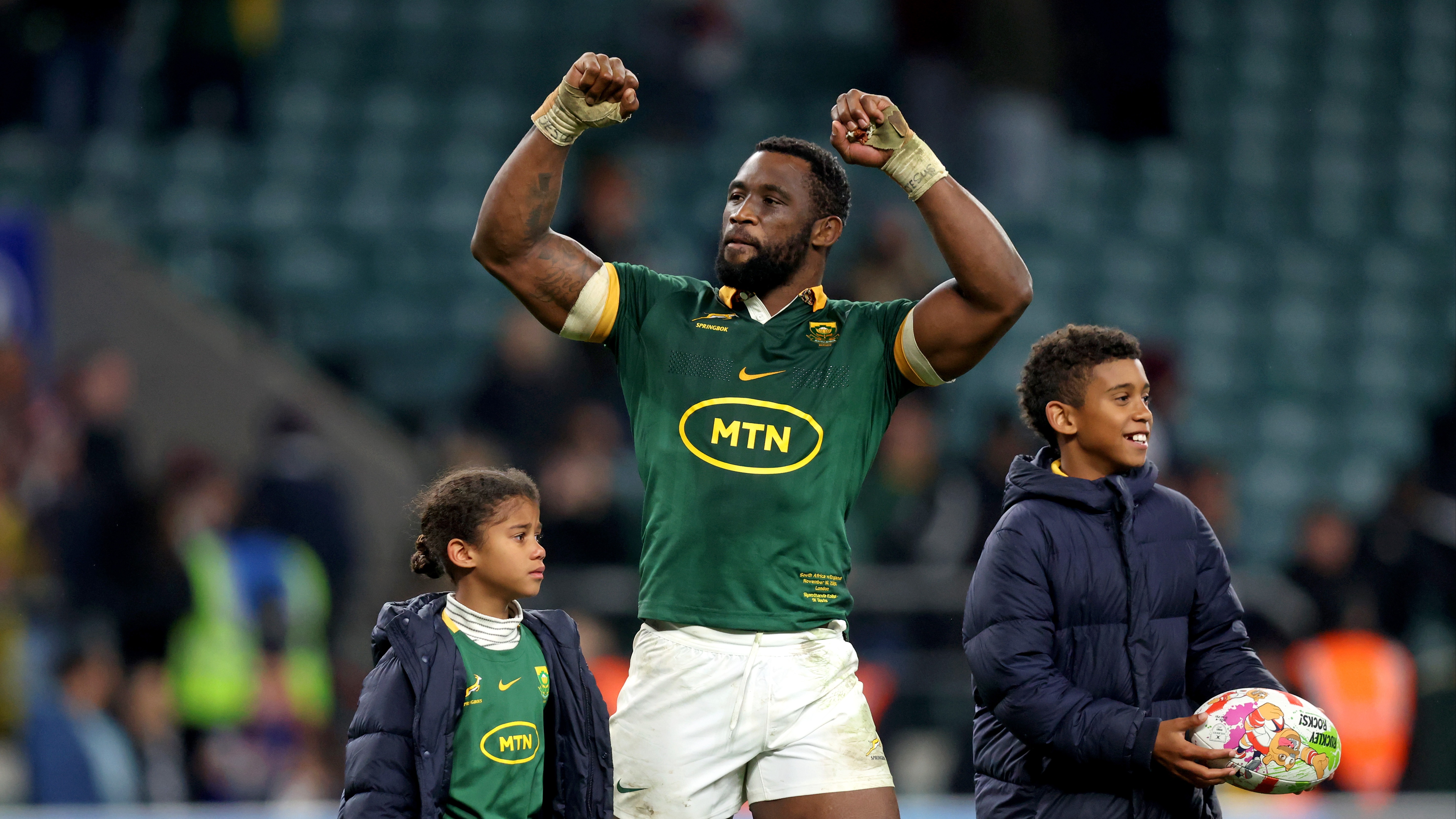Siya Kolisi celebrates on the field with his children after a Springboks victory in 2024.