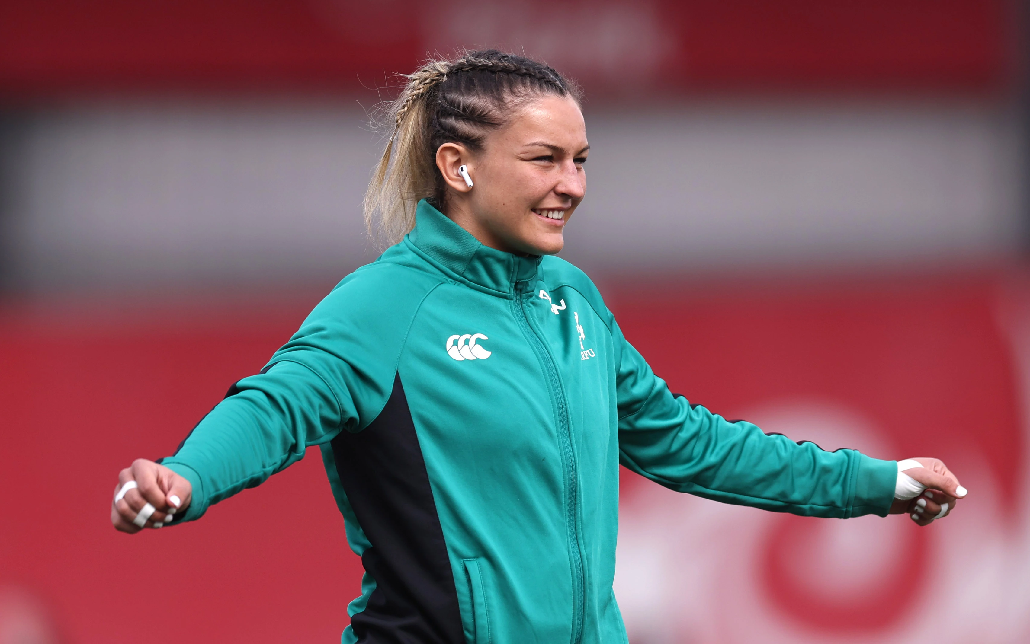 A smiling Erin King warms up for a 2025 Guinness Women's Six Nations match.