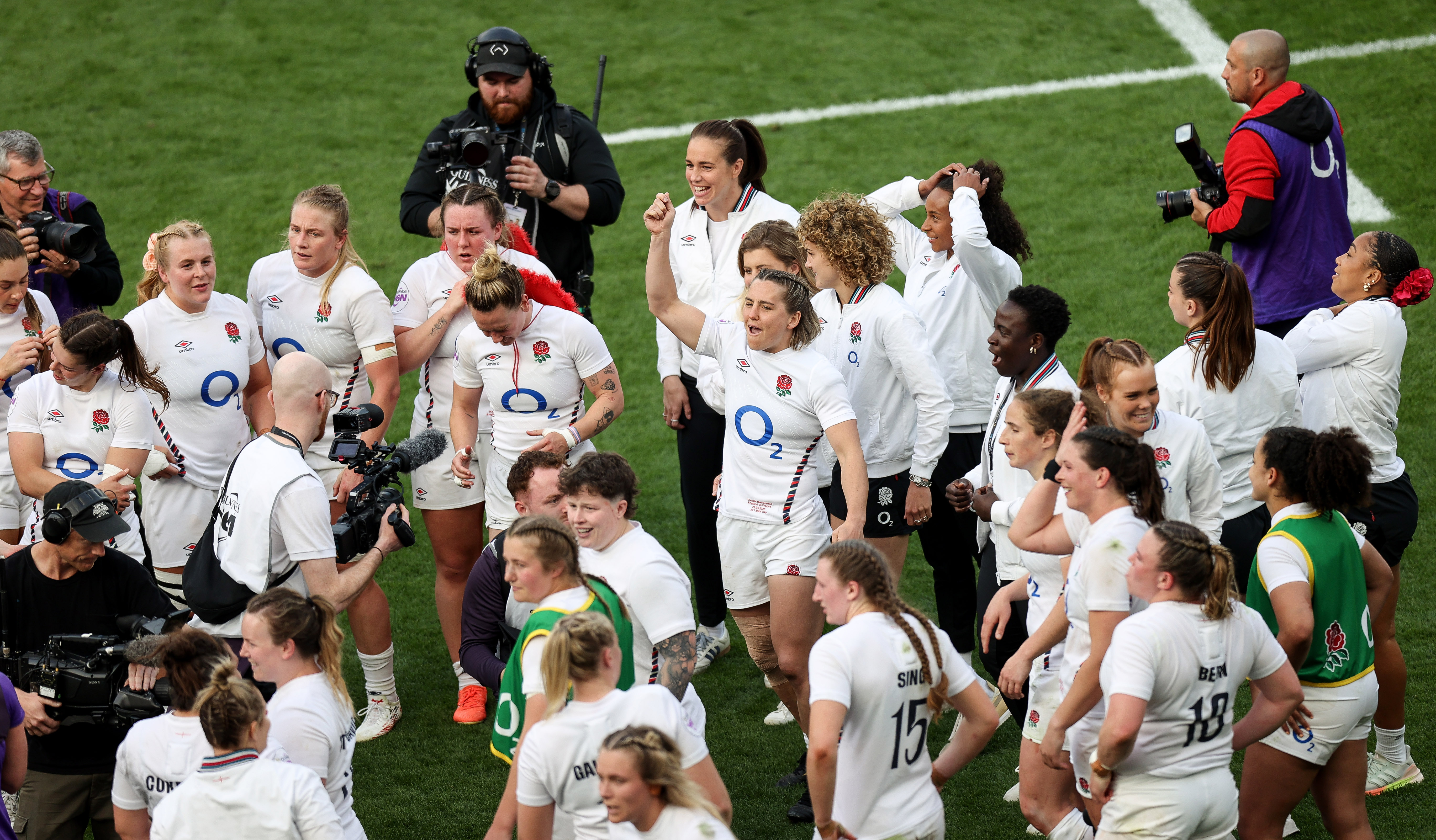 England's Claudia MacDonald celebrates among her teammates after the 2025 Grand Slam-winning match against France.